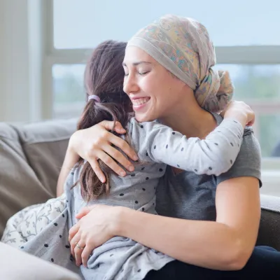 cancer patient and daughter hugging