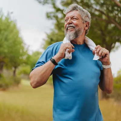 Man looking away holding a towel outdoor. 