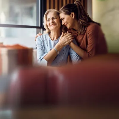 mother and daughter sitting at a table in a diner looking out the window