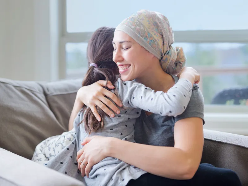 cancer patient and daughter hugging